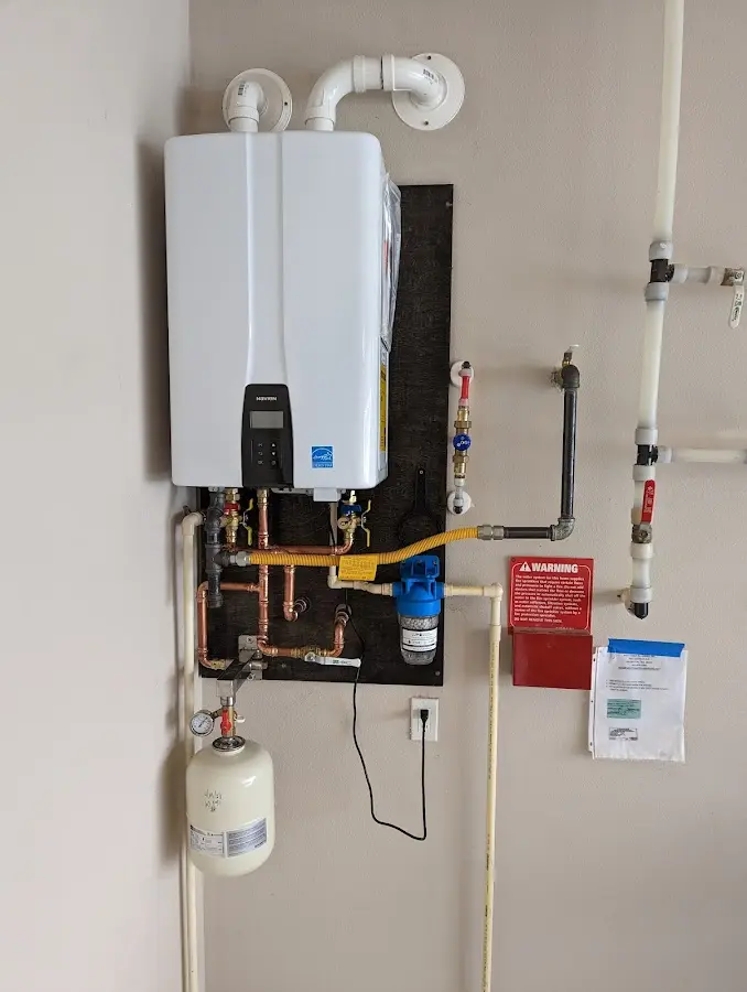 Professional plumber installing copper piping in a Ruskin home